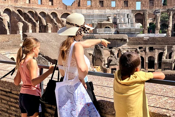 Visitors looking across the Colosseum from a main-level railing