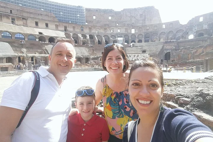 Visitors taking a photograph at a Colosseum interior overlook