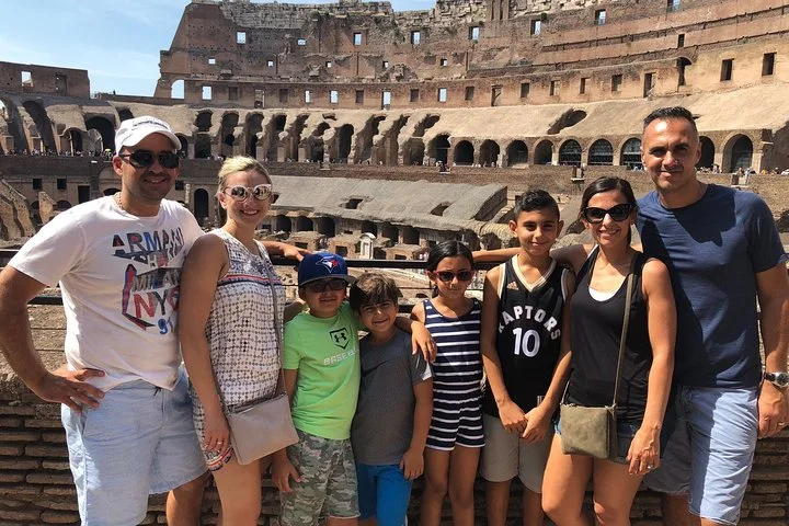 Adults and children at a main-level Colosseum overlook