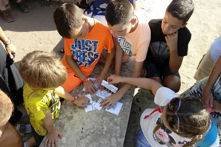Children completing a paper activity together