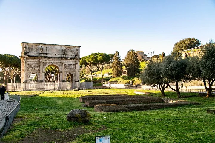 Arch of Constantine and green lawns beside the Colosseum