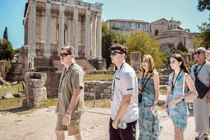 Visitors walking beside ancient Forum ruins