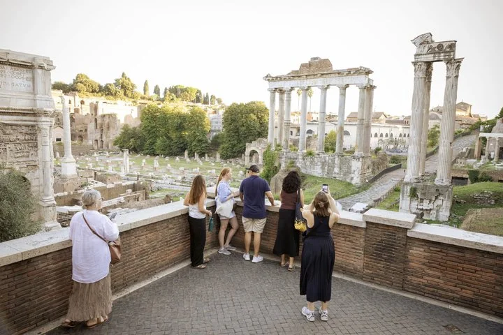Visitors looking across the Roman Forum from a terrace