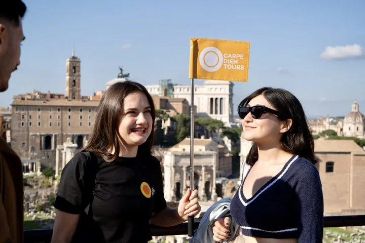Two visitors at a viewpoint above the Roman Forum
