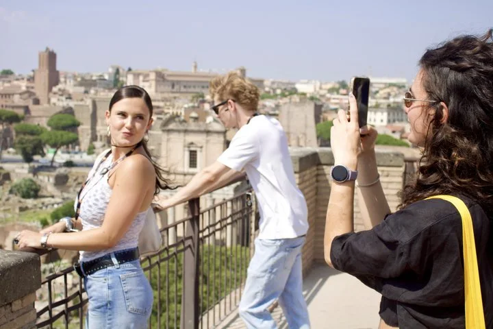 Visitors photographing one another at a Roman Forum overlook