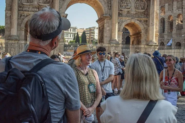 Guide and visitors beside the Arch of Constantine