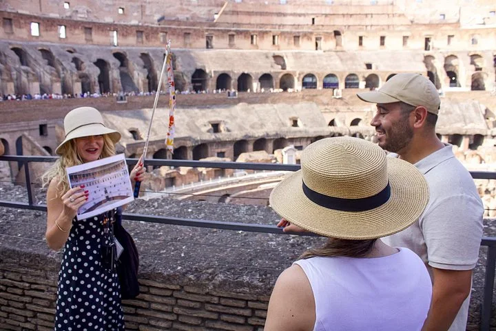 Guide and two visitors at a main-level Colosseum overlook