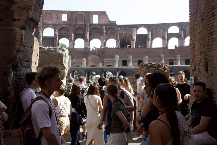 Visitors approaching the Colosseum interior through a low entrance