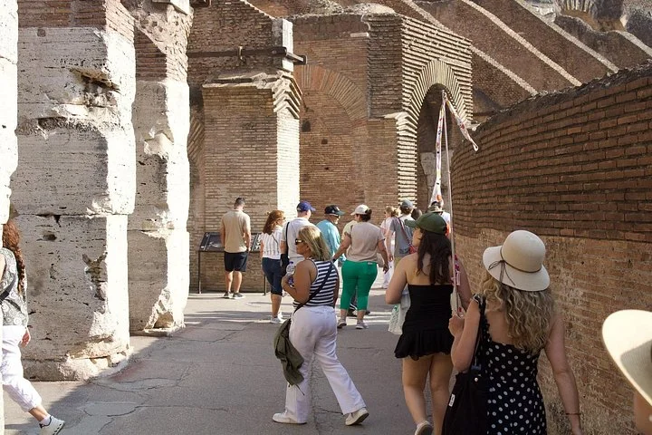 Visitors walking through the Colosseum main galleries