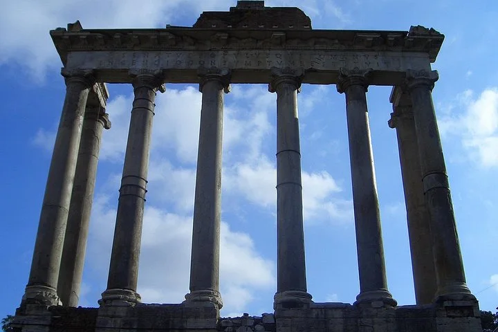 Temple columns silhouetted against clouds
