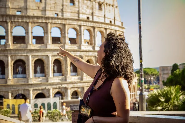 Guide pointing toward the Colosseum exterior