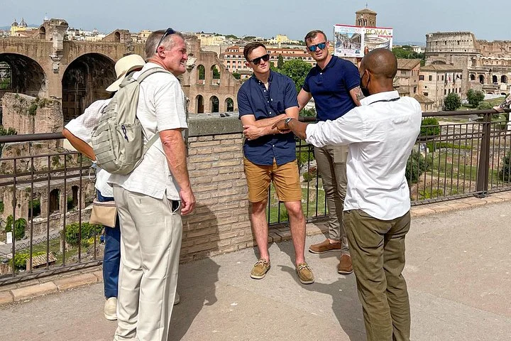 Guide and visitors beside a terrace over the Roman Forum