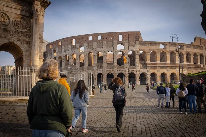 Visitors approaching the Colosseum across its public square