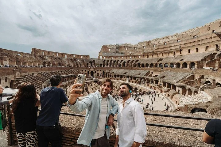 Visitors taking a photograph above the Colosseum interior