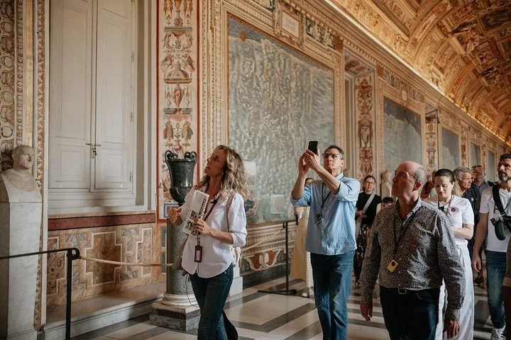 Guide and visitors in the Vatican Gallery of Maps