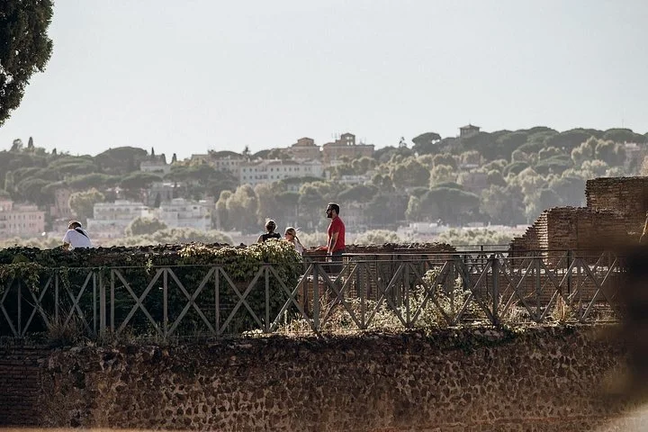 Visitors follow a walkway among Palatine Hill ruins.