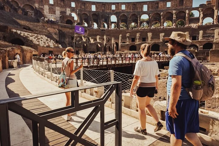 Visitors walking across the Colosseum arena platform