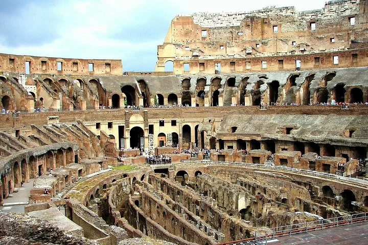 The Colosseum's arches rise above the exposed underground chambers.