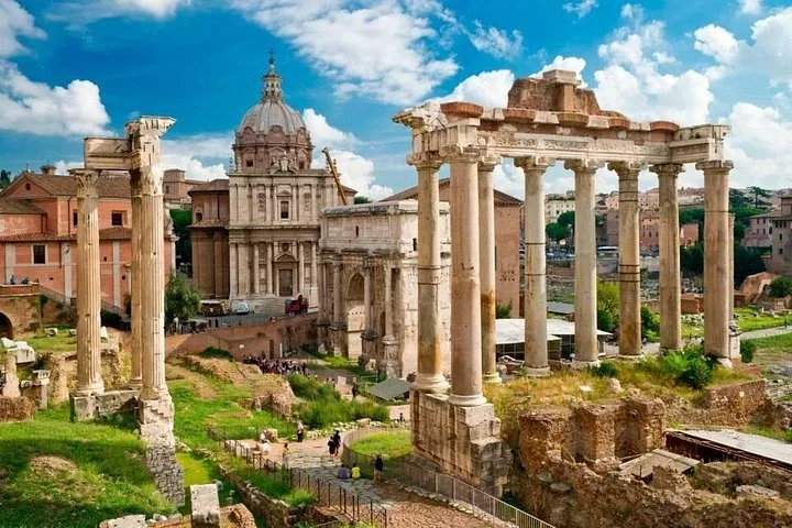Roman Forum temple columns and green ruins under a bright sky
