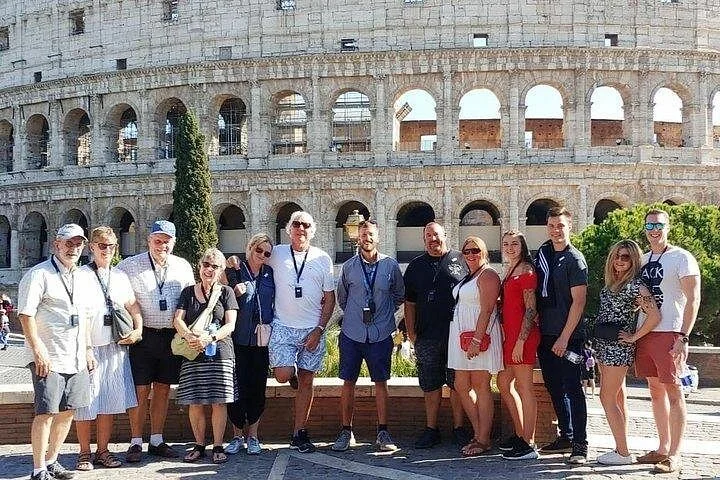 Visitors standing in front of the Colosseum exterior