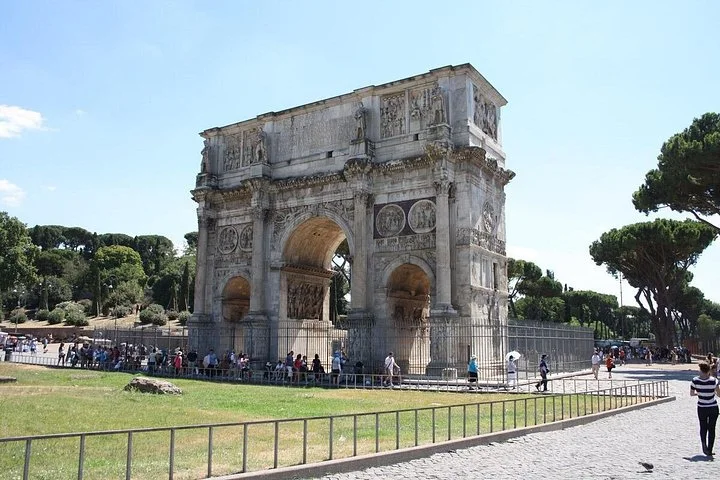 Arch of Constantine and green lawn beside the Colosseum