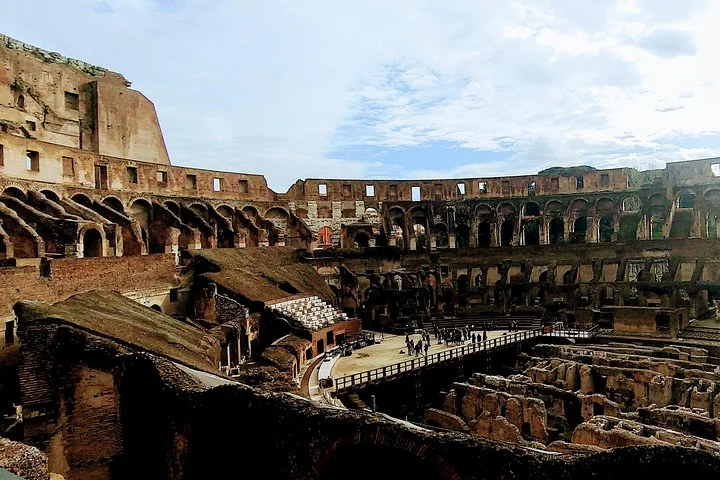 Wide interior view across the Colosseum from a visitor overlook