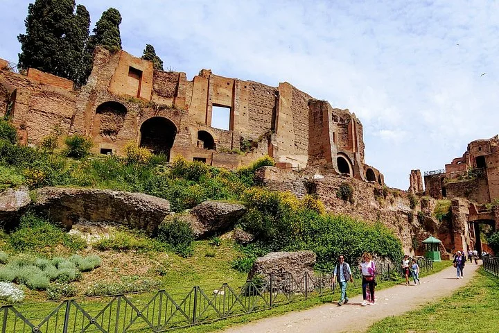 Green archaeological path below Palatine Hill palace walls