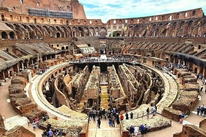 The Colosseum's underground ruins spread below its ancient seating tiers.