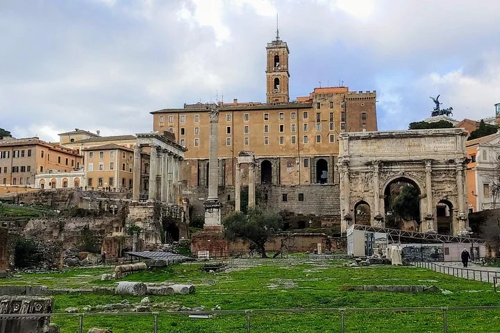Ancient columns and the Arch of Septimius Severus stand in the Roman Forum.