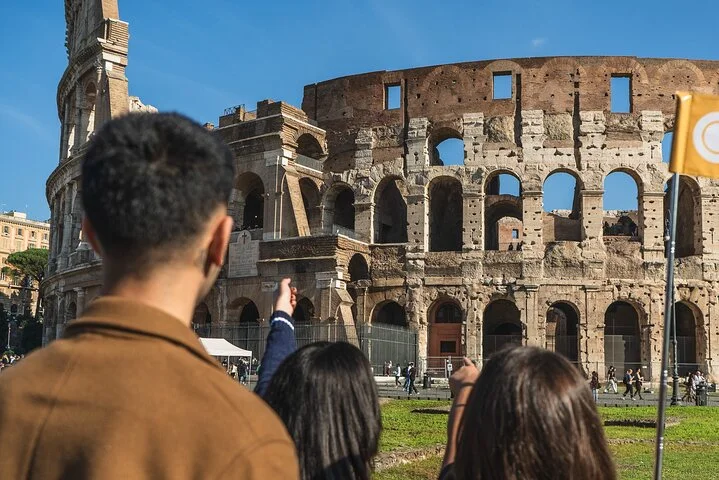 Guide and visitor looking toward the Colosseum exterior