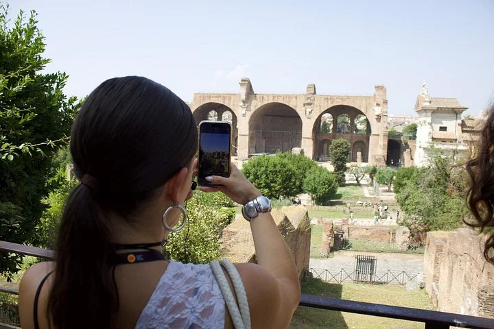 Visitor photographing the Basilica of Maxentius across the Forum