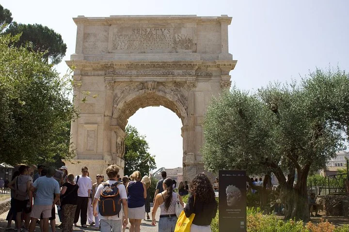 Visitors walking toward the Arch of Titus