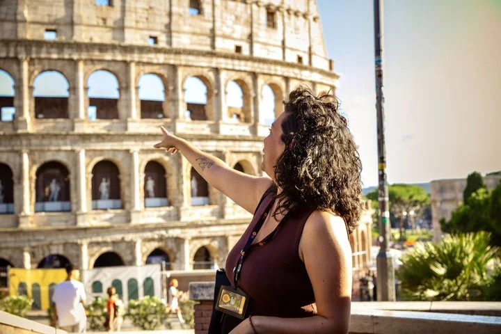 Guide pointing toward the Colosseum exterior