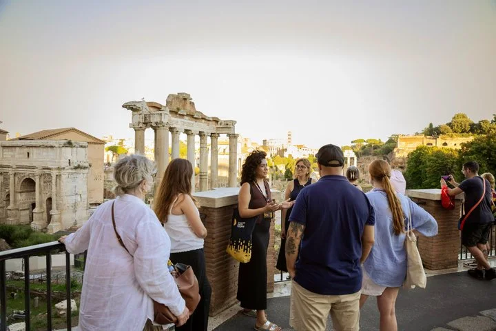 Guide and visitors on a terrace over the Roman Forum
