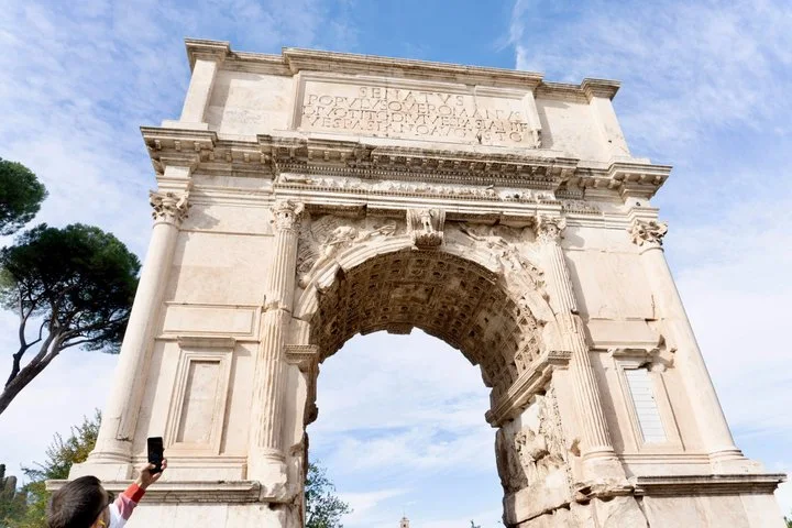 Arch of Titus beneath a blue sky