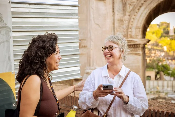 Guide speaking with a visitor inside a Colosseum arcade