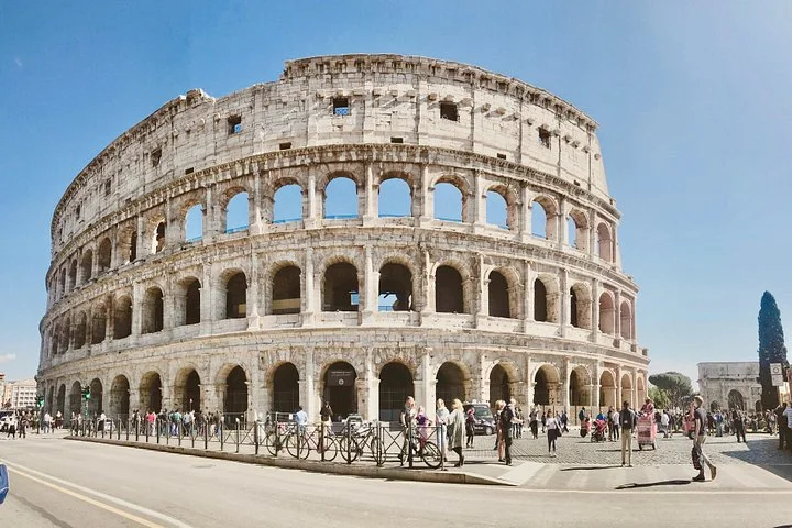 Wide Colosseum exterior and visitors in the public square