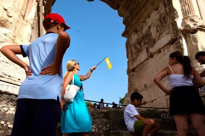 Guide and visitors beneath the Arch of Titus