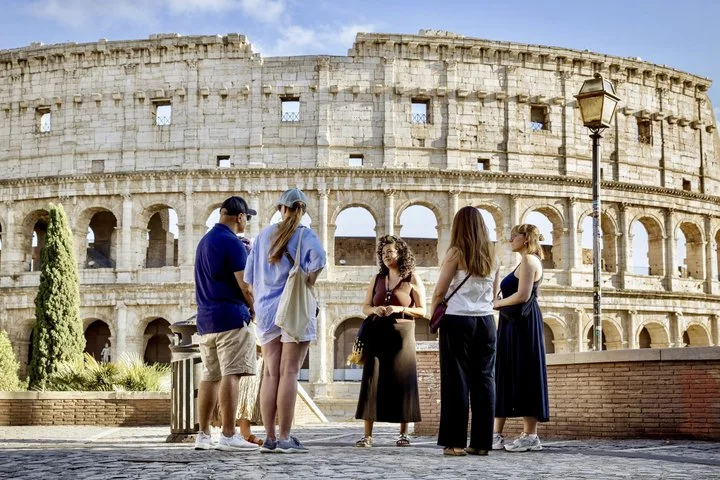 Visitors standing on a public terrace beside the Colosseum