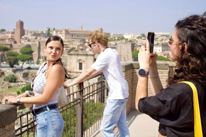 Visitors taking photographs at a Roman Forum overlook