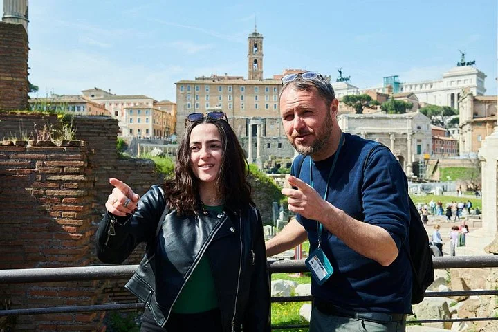 Guide pointing across the Roman Forum