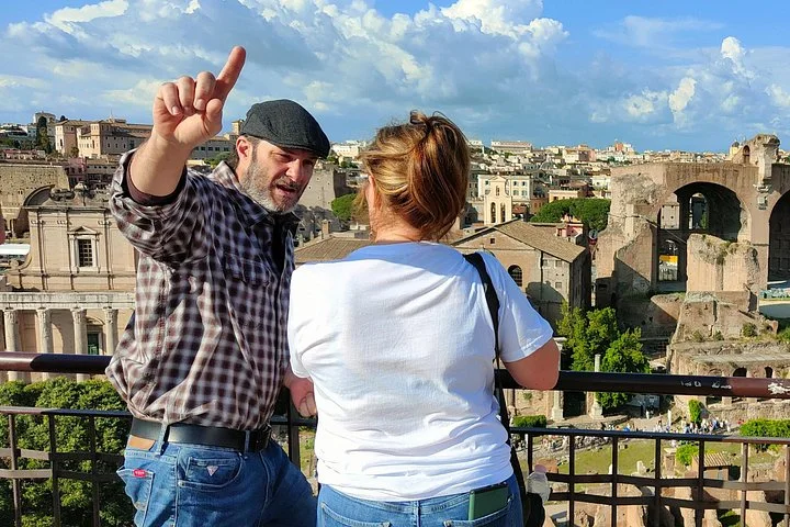 Guide explaining the Roman Forum from a terrace