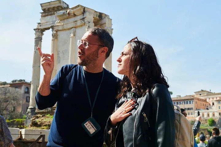 Guide and visitor beside ancient temple columns in the Roman Forum