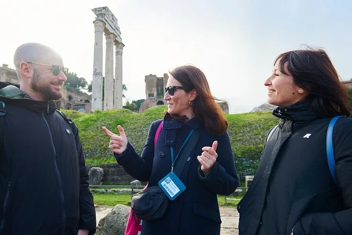 Guide speaking with visitors among Roman Forum columns
