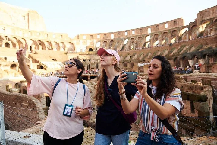 A guide points out details of the Colosseum from a visitor overlook.