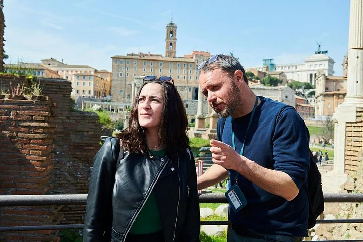 Guide and visitor with the Roman Forum skyline behind them