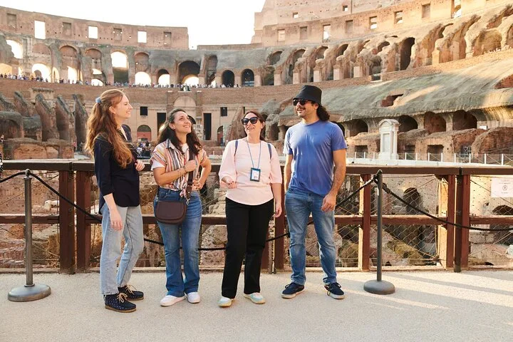 Guide and visitors on the Colosseum arena platform
