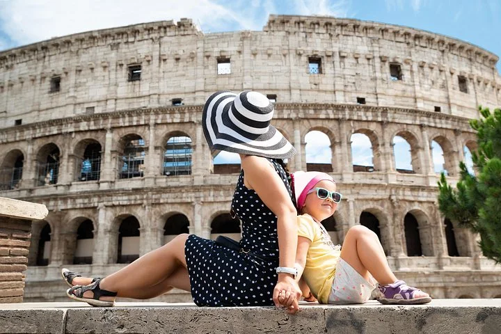 Two visitors on a public terrace beside the Colosseum