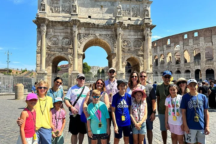Visitors beside the Arch of Constantine and Colosseum