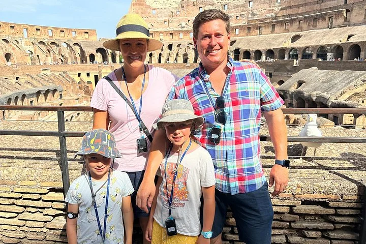 Adults and children at a stone-railed Colosseum overlook